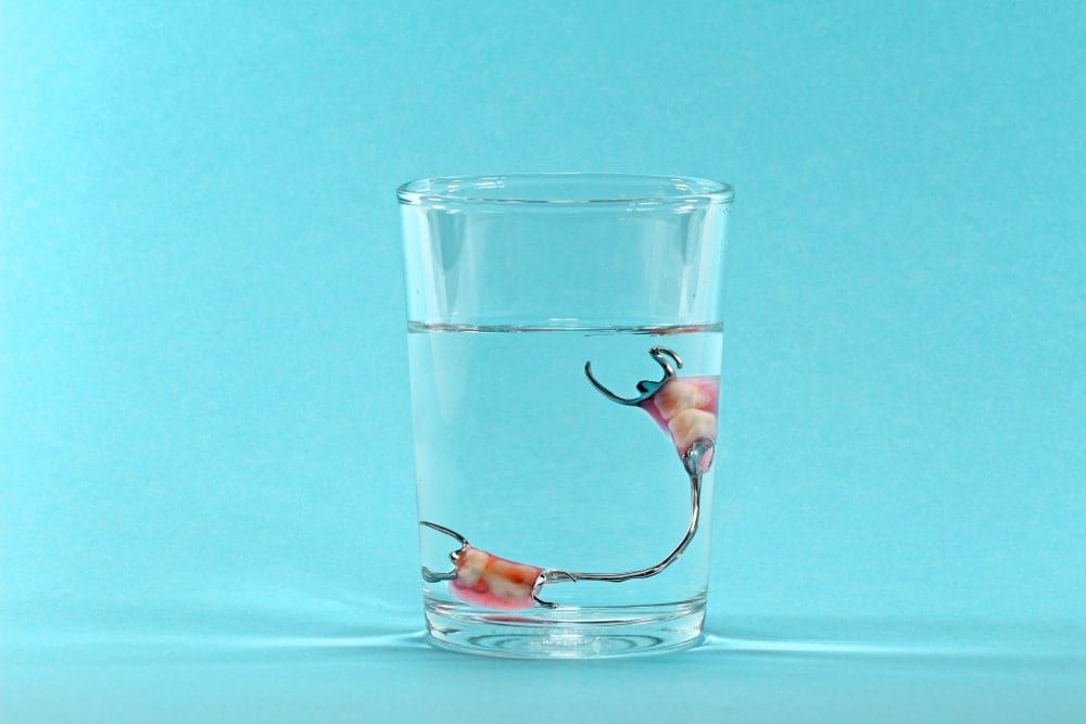 Partial denture in glass of water
